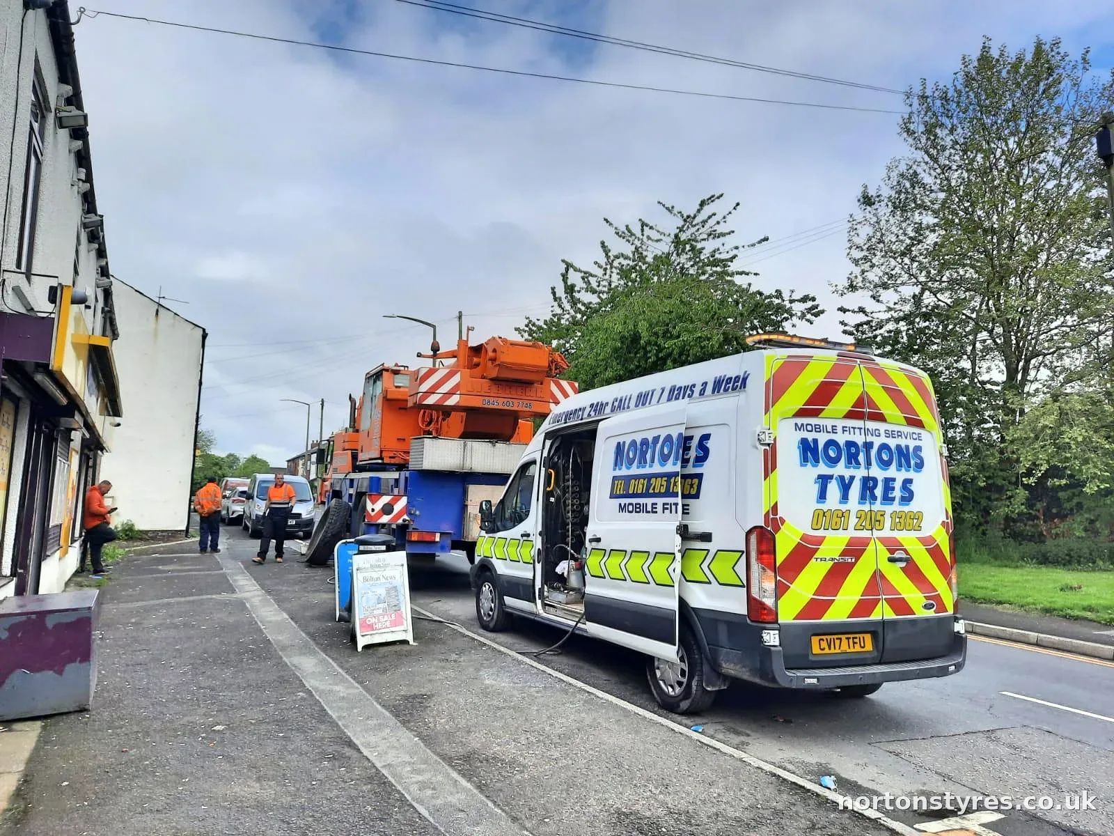 Nortons Tyres van attending a mobile crane in a residential street Nortons Tyres van attending a mobile crane in a residential street