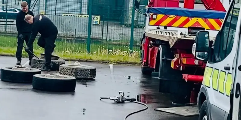 Fitters changing truck tyres beside a recovery truck Fitters changing truck tyres beside a recovery truck